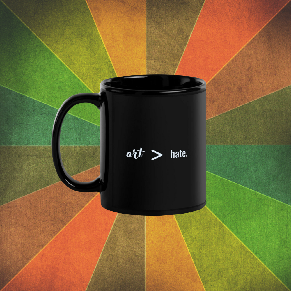 Black mug with 'art > hate' text on a colorful geometric background